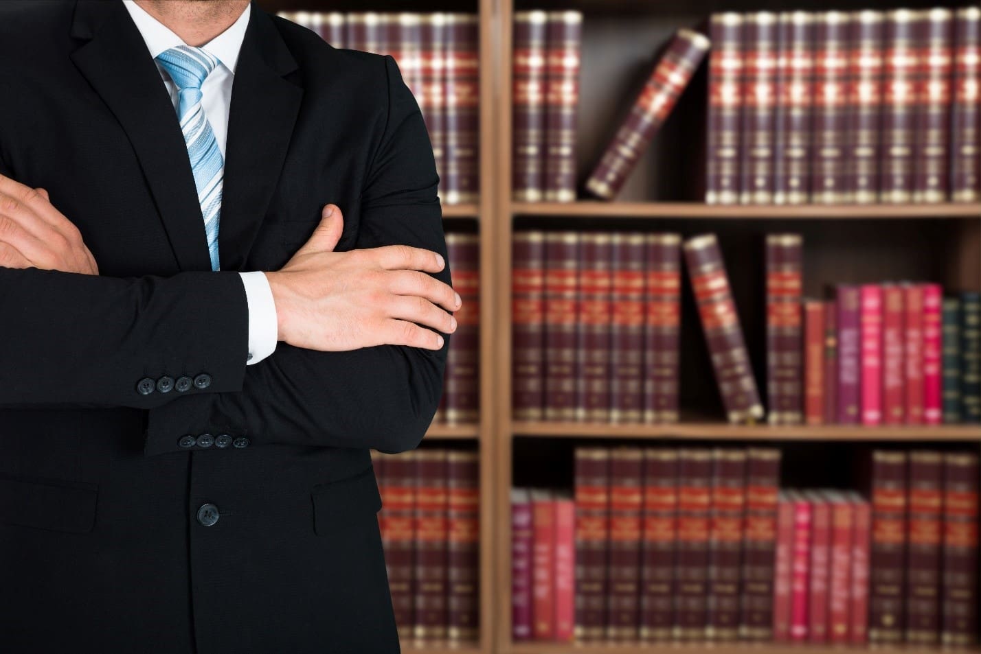 lawyer standing in front of law books Tabak Insurance