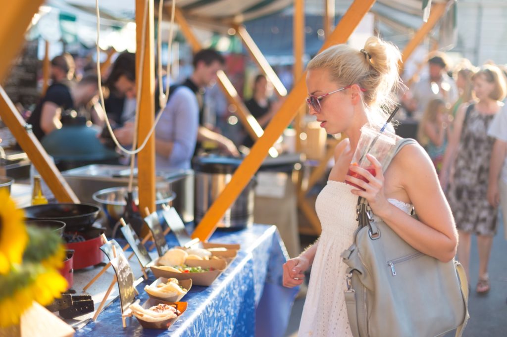 woman buying food from festival