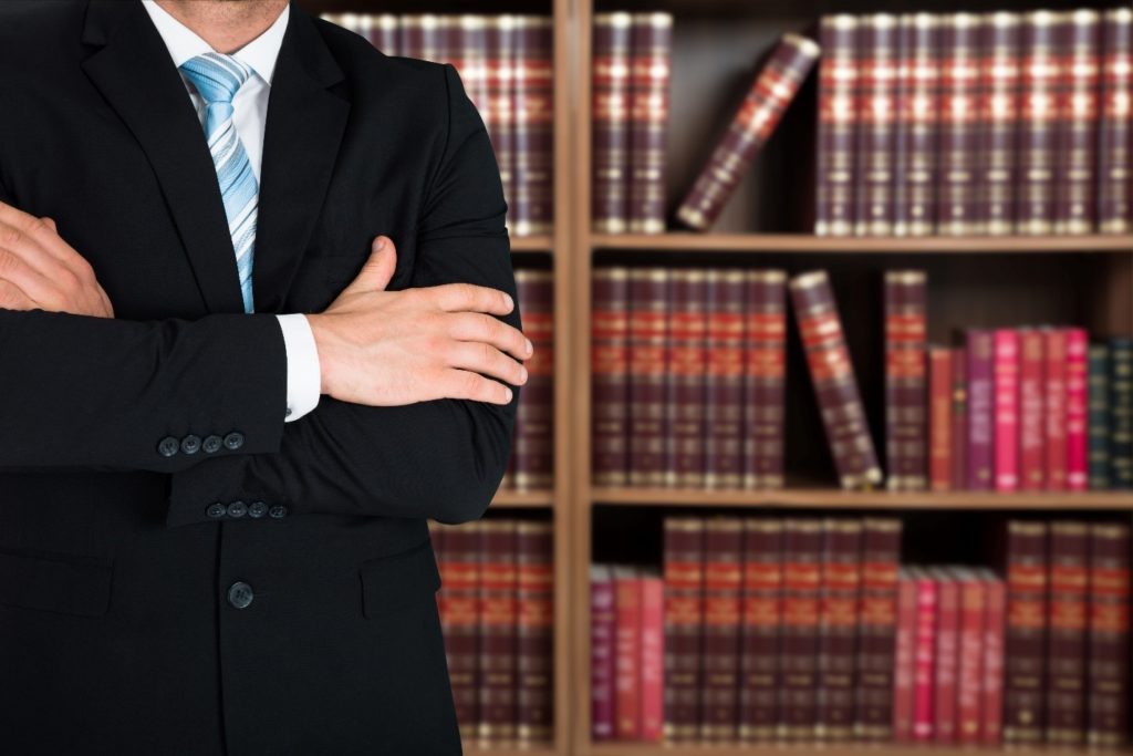 lawyer standing in front of law books