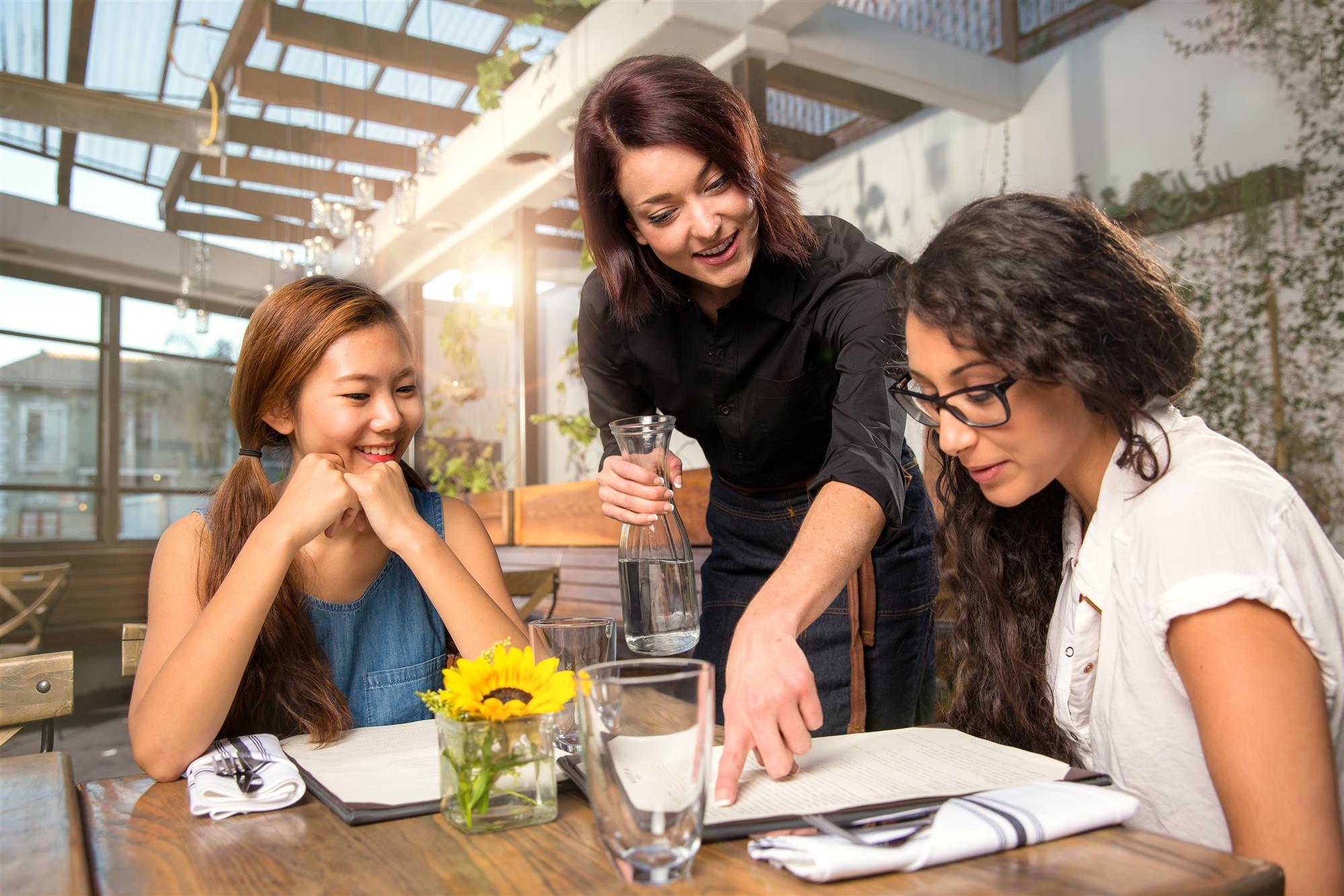 waiter pointing menu to customer